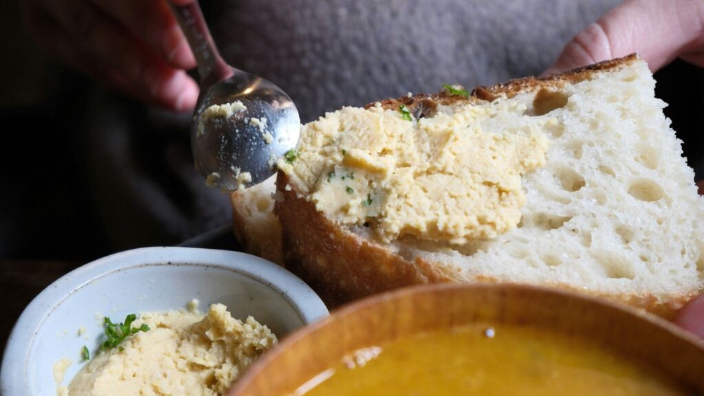 spoon of ghee beside warm homemade bread